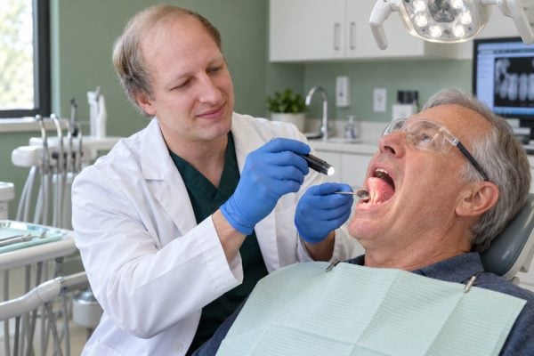 Dr. Ben Wasleske performing an oral cancer screening